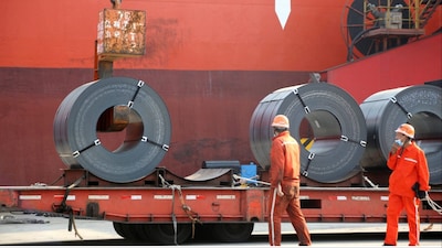 Workers load steel products for export to a cargo ship (File photo/Reuters)