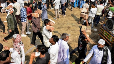 People carry bricks in view of former TMC MLA Humayun Kabir's plan to lay the foundation stone for a mosque, modelled on Ayodhya’s Babri Masjid. (PTI)