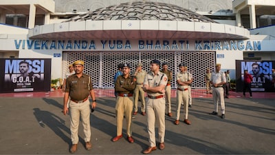 Police officials stand guard outside the Vivekananda Yuva Bharati Krirangan Stadium amid a probe into the chaos (PTI)