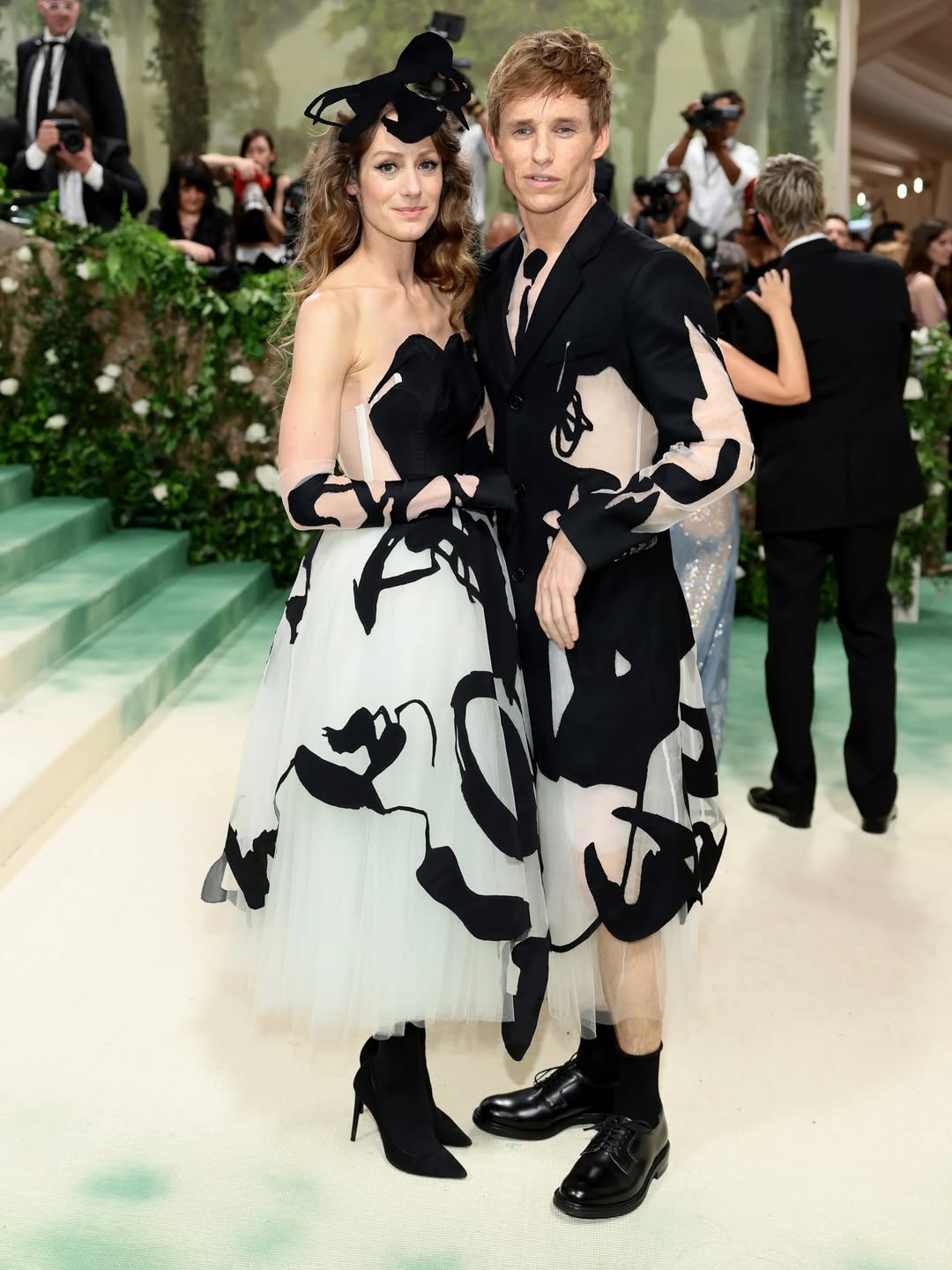 Eddie Redmayne and Hannah Bagshawe: At the MET Gala 2024, Eddie Redmayne and Hannah Bagshawe arrived in matching custom outfits designed by Steve O. Smith. Both ensembles featured dramatic layers of white tulle adorned with bold black blotches, creating a striking visual effect that echoed the night’s theme of theatricality and artistry.