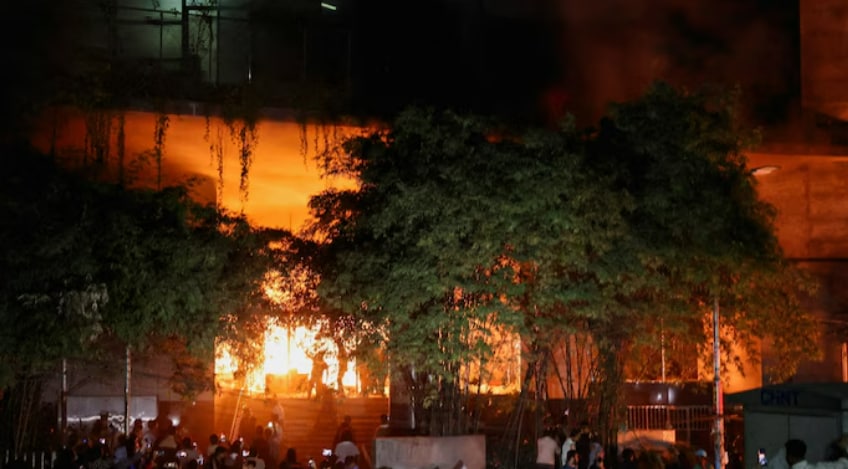 After news of his death spread, large crowds gathered in Dhaka and other cities, demanding the arrest of those behind the attack. Some reportedly turned to arson and vandalism. Authorities said buildings housing media offices like The Daily Star and Prothom Alo were set on fire, trapping staff inside. In Rajshahi, protesters reportedly used a bulldozer to demolish a local office of the Awami League, former PM Sheikh Hasina’s party.