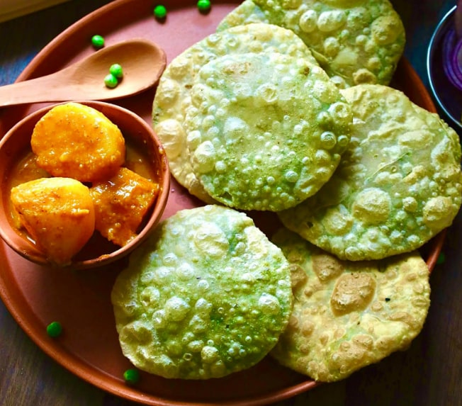 In Bengal, peas are transformed into Koraishutir Kochuri. It is a crispy, fried, puffy bread stuffed with spiced pea paste. They are usually eaten for breakfast in winter and taste best with a simple curry. For many Bengalis, winter seems incomplete without this narrative.