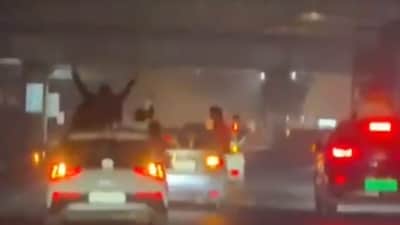Men were filmed performing dangerous stunts and racing cars on Delhi roads, sparking safety concerns. Delhi Police traced violators and warned strict action after similar incidents. 