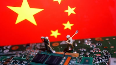 Worker miniatures are placed among the flag of China and printed circuit boards with semiconductor chips, in this illustration picture taken July 5, 2023. (REUTERS)