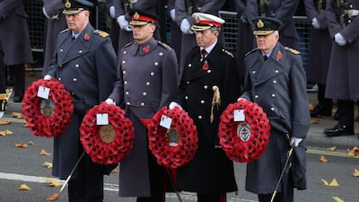 General Sir Charles Roland Walker (2L) and Sir Richard Knighton (R) lay wreaths during the Remembrance Sunday ceremony at the Cenotaph on Whitehall in central London. (IMAGE: AFP)