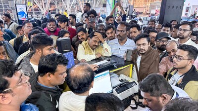 Stranded passengers try to get answers from IndiGo officials. (PTI)