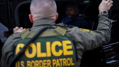 US Border Patrol commander Greg Bovino looks at a detainee sitting in a car, after Donald Trump launched an immigration crackdown in Louisiana, US. (REUTERS)