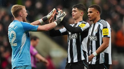 Newcastle United goalkeeper Aaron Ramsdale, left, celebrates with Lewis Miley (67) and Malick Thiaw (12) after the English League Cup quarterfinal soccer match between Newcastle and Fulham in Newcastle upon Tyne, England, Wednesday, Dec. 17, 2025. (Owen Humphreys/PA via AP)