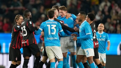 Napoli's Scott McTominay argues with AC Milan's Strahinja Pavlovic during an Italian Super Cup soccer match between Napoli and AC Milan in Riyadh, Saudi Arabia, Thursday, Dec. 18, 2025. (AP Photo/Altaf Qadri)