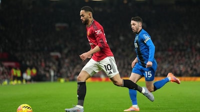 Bournemouth's Adam Smith runs after Manchester United's Matheus Cunha during a Premier League soccer match between Manchester United and Bournemouth in Manchester, England, Monday, Dec. 15, 2025. (AP Photo/Jon Super)
