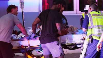 Emergency workers transport a person on a stretcher after a reported shooting at Bondi Beach (Picture credit: AP)