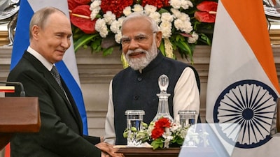 Russian President Vladimir Putin (L) speaks with PM Narendra Modi after their joint press statements at the Hyderabad House in New Delhi on December 5, 2025. (Image: AFP)