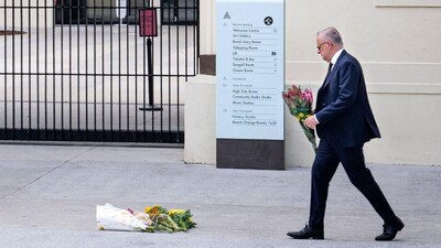 A handout photo taken and released by the Australian Prime Minister's Office on December 15, 2025 shows Australia's Prime Minister Anthony Albanese laying flowers at the Bondi Pavillion at Bondi Beach. (AFP)