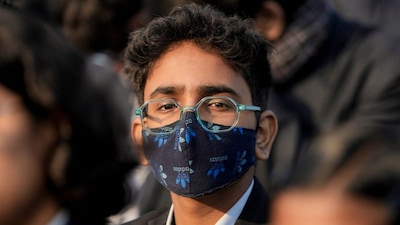 A student wears a mask during an event due to deteriorated air quality in New Delhi. (Image: PTI)