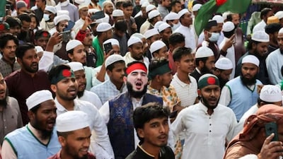Members of the multiple organisations including Khelafat Majlis join in a protest rally after Friday prayer, demanding justice for the death of Sharif Osman Hadi.(REUTERS)