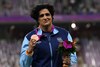 Seema Punia celebrates on the podium during the medal ceremony for the women&#x27;s discus throw final athletics event during the 2022 Asian Games (Picture credit: AFP)