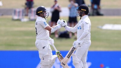 Devon Conway celebrates his century with Tom Latham (Picture credit: AFP)