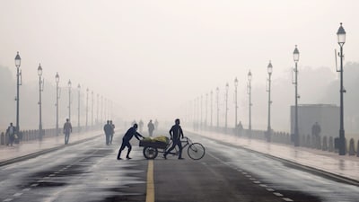 People at the Kartavya Path on a cold and smoggy winter morning, as air quality remains poor in New Delhi on November 27, 2025. (Image: PTI)