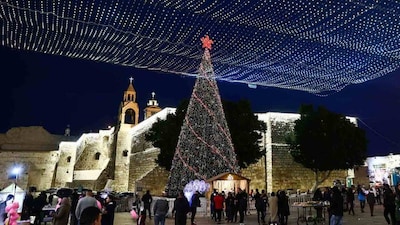 Bethlehem revives Christmas festivities amid war and fragile Gaza ceasefire, with Manger Square bustling and hope alive despite economic hardship.