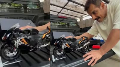 John Abraham receives a working miniature Suzuki Hayabusa from a fan. 