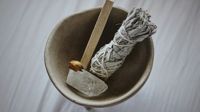 A bundle of sage and a crystal stone for energy cleansing routine