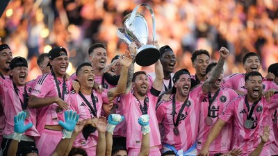 Lionel Messi hoists the trophy alongside teammates after defeating the Vancouver Whitecaps in the MLS Cup final. (AP Photo)