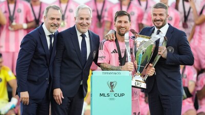 Inter Miami owners Jose Mas, left, his brother Jorge Mas and David Beckham pose with the MLS Cup trophy with forward Lionel Messi. (AP Photo)
