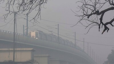 A train runs on Red Line of the Delhi Metro amid low visibility due to a layer of smog, in New Delhi, on Sunday. (PTI)