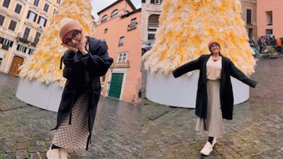 Rashmika poses with a white Christmas tree.