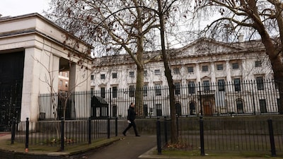 A man walks past Royal Mint Court, the proposed site of China's planned mega‑embassy, after the government approved China's application to redevelop the former Royal Mint site in east London, Britain, January 20, 2026. REUTERS/Jack Taylor