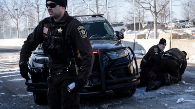 Federal officers shot and killed a person in Minneapolis during a DHS immigration operation, prompting protests and calls to end the crackdown.(Photo by ROBERTO SCHMIDT / AFP)