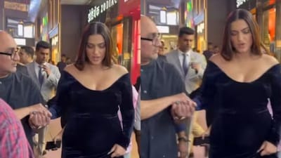 Sonam Kapoor is helped by a friend while walking as she attends Mumbai event.