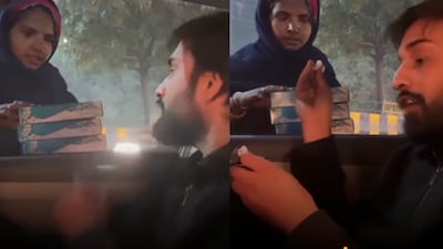 A still from the video shows a man guiding a young street vendor.  (Photo Credit: Instagram)