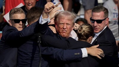 Donald Trump is assisted by the Secret Service after gunfire rang out during a campaign rally at the Butler Farm Show in Butler, Pennsylvania, US. (IMAGE: REUTERS FILE) 