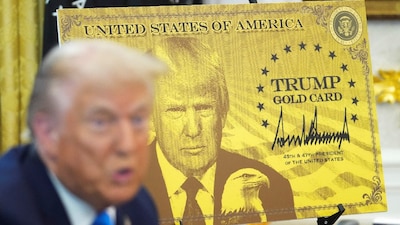 US President Donald Trump speaks as he sits next to a "Trump Gold Card" sign, in the Oval Office at the White House in Washington, DC, US. (IMAGE: REUTERS) 