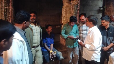 Kuttadi Tirupati (hands tied, in centre, sitting) scaled the temple gopuram late at night, damaged kalashams and was arrested after a three-hour police operation. (IMAGE: NEWS18/SOURCED) 