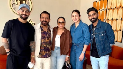 Anushka Sharma keeps it effortlessly chic in a classic denim-on-denim look, pairing a structured blue shirt with bootcut jeans and minimal accessories for a polished yet relaxed vibe.