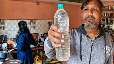 A person shows a sample of the drinking water that is being collected following a diarrhoea outbreak caused by contaminated water, at Bhagirathpura area, in Indore, Madhya Pradesh. (PTI Photo)