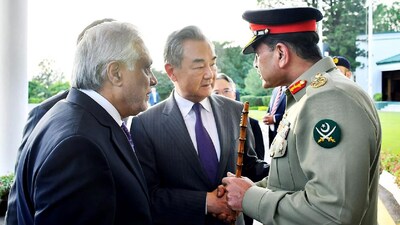 Pakistan's Foreign Minister Ishaq Dar (L) and Pakistani Army Chief General Syed Asim Munir (R) greet Chinese Foreign Minister Wang Yi (C) upon his arrival for a meeting in Rawalpindi. (IMAGE: AFP FILE) 