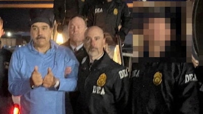 Venezuela's captured President Nicolas Maduro poses next to U.S. DEA administrator Terry Cole. (Handout via REUTERS/File Photo)