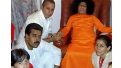 Photographs from 2005 show Nicolas Maduro and Flores kneeling before the guru during a visit to his Prasanthi Nilayam ashram.