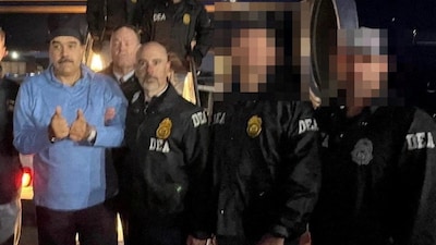 Venezuela's captured President Nicolas Maduro poses next to U.S. Drug Enforcement Administration (DEA) administrator Terry Cole as he is led in custody from a US federal airplane, at Stewart Air National Guard Base in Newburgh, New York, US. (IMAGE: REUTERS) 