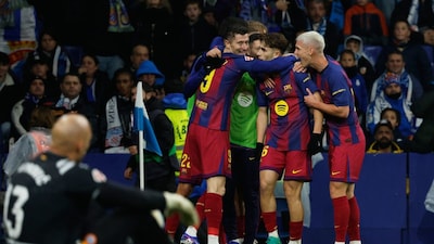 Barcelona's Robert Lewandowski (9) is congratulated after scoring his side's 2nd goal during the Spanish La Liga soccer match between RCD Espanyol and Barcelona in Barcelona, Spain, Saturday, Jan. 3, 2026. (AP Photo/Joan Monfort)