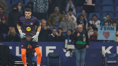 Barcelona's goalkeeper Joan Garcia warms up prior to the Spanish La Liga soccer match between RCD Espanyol and Barcelona in Barcelona, Spain, Saturday, Jan. 3, 2026. (AP Photo/Joan Monfort)
