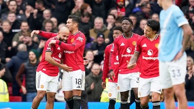 Manchester United's Bryan Mbeumo, left, celebrates after scoring his side's opening goal during the English Premier League soccer match between Manchester United and Manchester City in Manchester, England, Saturday, Jan. 17, 2026. (AP Photo/Dave Thompson)
