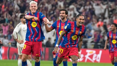 Barcelona's Raphinha, center, celebrates after scoring his second goal during the Spanish Super Cup final soccer match against Real Madrid at King Abdullah Sports City Stadium in Jeddah, Saudi Arabia, Sunday, Jan. 11, 2026. (AP Photo/Altaf Qadri)