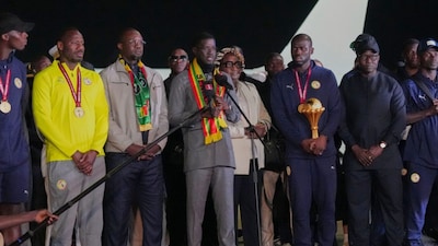 Senegal's President Bassirou Diomaye Faye, center left, delivers a speech as Senegal's team arrives at Blaise Diagne International Airport following their victory in the Africa Cup of Nations soccer tournament, in Ndiass, Senegal, Tuesday, Jan. 20, 2026. (AP Photo/Misper Apawu)