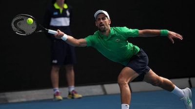 Novak Djokovic of Serbia plays a forehand return to Lorenzo Musetti of Italy during their quarterfinal match at the Australian Open tennis championship in Melbourne, Australia, Wednesday, Jan. 28, 2026. (AP Photo/Dita Alangkara)