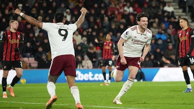 Arsenal's Declan Rice, right, runs to celebrate after scoring his third goal during the English Premier League soccer match between Bournemouth and Arsenal in Bournemouth, England, Saturday, Jan. 3, 2026. (AP Photo/Alastair Grant)