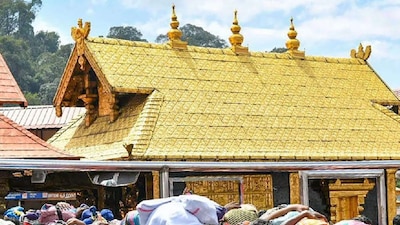 Devotees stand in a queue to offer their prayers at the Lord Ayyappa temple in Sabarimala. (IMAGE: PTI)